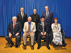 Catholic Charities Indianapolis presented four individuals with Spirit of Service Awards during an April 30 dinner in Indianapolis. Award recipients, seated from left, are James Morris, Robert &ldquo;Lanny&rdquo; Rossman, Yan Yan and Liz Stanton. Standing, from left, are keynote speaker Ed Carpenter, Archbishop Charles C. Thompson and David Bethuram, executive director of the archdiocese&rsquo;s Catholic Charities. (Submitted photo by Rob Banayote)