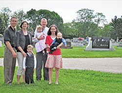 Members of St. Mary Parish&rsquo;s Miscarriage Ministry in Greensburg stand at the spot of the soon-to-be built Little Souls Cemetery. Pictured are Dan, left, and Diane Scheidler; John Harpring; Chris Harpring, holding Philomena Harpring; and Rebecca Harpring holding Louis Harpring. The families are spearheading the ministry at the parish to help women know they can bury their miscarried babies. (Submitted photo)