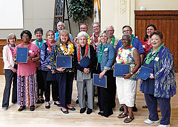 Among those recognized for years of service during the Catholic Charities Indianapolis volunteer dinner on May 16 at the Archbishop Edward T. O&rsquo;Meara Catholic Center in Indianapolis are: front row, Lorette Morgan, left, Iris Parrish, Sue Sandefur, Rita Tomson, Jessica Limeberry, Valerie Cook and Debbie Whitaker. Back row: Charlene Glawe, left, Margaret Voyles, Mike Parrish, Deacon Michael Braun, archdiocesan executive director of Catholic Charities David Bethuram, Robert Hughes, Tom Kueper and Jaqueline Pimentel-Gannon, president of the Catholic Charities Indianapolis Agency Council. (Photo by Mike Krokos)