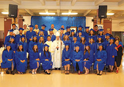 Graduates of the archdiocesan Hispanic Pastoral Leadership Institute are pictured with Archbishop Charles C. Thompson and several priests after a graduation liturgy at St. Andrew the Apostle Church in Indianapolis on June 15. All told, 34 graduates&mdash;27 in pastoral leadership, and seven in spiritual direction&mdash;received certificates on that day. (Photo by Mike Krokos)