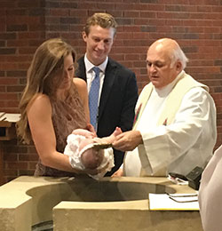 Father Jerry Kirkhoff baptizes his great-great niece, Grace Kirkhoff, while her godparents&mdash;Maryann Kirkhoff and Michael Bower&mdash;take part in the sacrament at St. Barnabas Church in Indianapolis on Aug. 18, 2018. (Submitted photo)