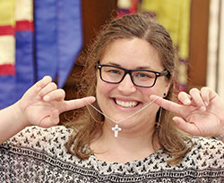 After professing her first vows as a Sister of Providence at Church of the Immaculate Conception in Saint Mary-of-the-Woods on June 30, Providence Sister Emily TeKolste displays the symbol identifying her with the congregation—a white cross with a black emblem representing Christ in the world. (Submitted photo)
