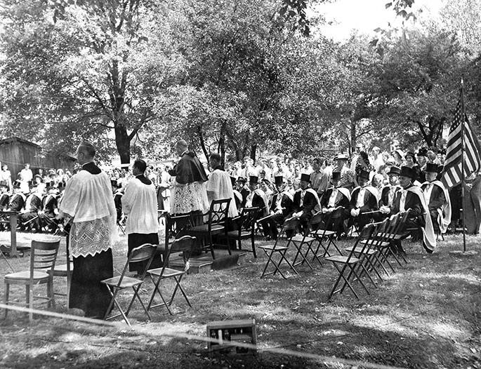 In this photo, an outdoor Mass takes place as part of “Rural Life Day” at St. Michael Parish in Bradford in July 1949. Archbishop Paul C. Schulte is seen from behind. This event in the New Albany Deanery faith community included a field Mass, talks by clergy and laity on the needs of rural Catholics, a picnic, games and folk dances, and solemn benediction of the Blessed Sacrament. The National Catholic Rural Life Conference was founded on Nov. 11, 1923, to serve the needs of Catholic farmers in America. Local “Rural Life Days” are among the events sponsored by the conference, which still occur today in some areas of the country.