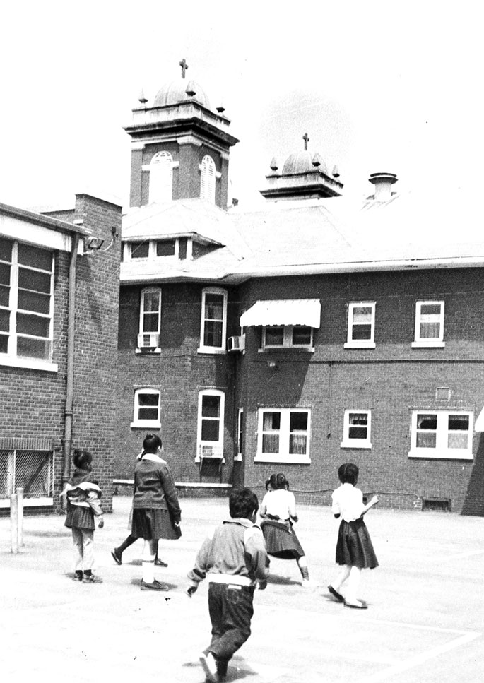 Students play outside during recess near the former St. Francis de Sales Church in Indianapolis in this photo from May 15, 1983. The former St. Francis de Sales Parish in the Brightwood neighborhood was founded in 1881 but closed on June 30, 1983, along with its school, due to declining membership caused by the construction of Interstate 70. The church building is now the home of the Father Boniface Hardin Gathertorium at Martin University.