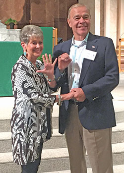 After the annual archdiocesan Golden Wedding Anniversary Mass at SS. Peter and Paul Cathedral in Indianapolis on Aug. 25, Jan and Charles Lauck of St. Barnabas Parish in Indianapolis make a “50” with their hands to indicate the number of years they’ve been married. (Photo by Natalie Hoefer)