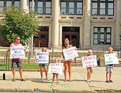 Denis, left, Ava, Raelyn, Buffy, Tessa and Carter O&rsquo;Brien, members of St. Jude Parish in Indianapolis, give witness as a family along North Meridian Street in Indianapolis during the national LifeChain event on Oct. 7, 2018. (File photo by Natalie Hoefer)