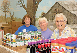During an open house at Providence Food Pantry in West Terre Haute on Sept. 22, volunteers Randi Everett, left, Grace Puller and Annie Williams smile behind boxes of items offered by the ministry. The open house was held to mark Providence Food Pantry&rsquo;s 25th anniversary. (Submitted photos by Shayna Tews)