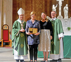 Barbara Hinkle, a member of St. Gabriel Parish in Connersville, holds the Archbishop Edward T. O&rsquo;Meara Respect Life Award she received at SS. Peter and Paul Cathedral in Indianapolis on Oct. 6. Posing with her are Archbishop Charles C. Thompson, archdiocesan Office of Human Life and Dignity coordinator Brie Anne Varick, and Deacon Michael Braun, director of the archdiocesan Secretariat for Pastoral Ministries. (Photo by Natalie Hoefer)