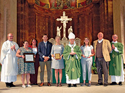 Archbishop Charles C. Thompson is pictured in SS. Peter and Paul Cathedral in Indianapolis on Sept. 25 with archdiocesan staff and the winners of awards that were presented in the areas of Catholic education, catechesis and youth ministry. Pictured, left, SS. Peter and Paul rector Father Patrick Beidelman, who also serves as executive director of the Secretariat for Worship and Evangelization; education honoree Sarah Jean Watson; archdiocesan superintendent of schools Gina Fleming; director of the archdiocese&rsquo;s Office of Youth Ministry Paul Sifuentes; youth ministry honoree Monica Robinson; Archbishop Thompson; catechesis honoree Marianne Hawkins; archdiocesan director of catechesis Ken Ogorek; and archdiocesan director of the Secretariat for  Pastoral Ministries Deacon Michael Braun. (Photo by John Shaughnessy)
