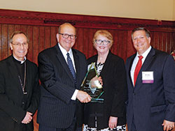 Archbishop Charles C. Thompson is pictured with the St. Thomas More Society&rsquo;s &ldquo;Couple for All Seasons Award&rdquo; honorees on Oct. 1 in the Archbishop Edward T. O&rsquo;Meara Catholic Center in Indianapolis. Pictured are Archbishop Thompson, left; honorees Judge Brent Dickson and Jan Aikman Dickson; and Patrick Olmstead Jr., president of the St. Thomas More Society of Central Indiana. (Photo by Mike Krokos)