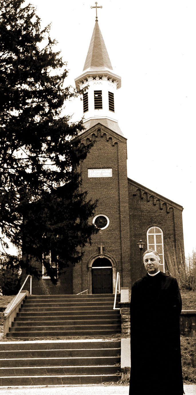 This photo of Benedictine Father Edwin Miller standing near St. Boniface Church in Fulda was taken as the parish, founded in 1847, prepared to celebrate the centennial of its church building in 1965. A special centennial Mass was celebrated by Archbishop Paul C. Schulte and Benedictine Archabbot Bonaventure Knaebel, of Saint&nbsp;Meinrad Archabbey on May 2,&nbsp;1965. The church was listed on the National Register of Historic Places in 1980.