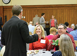 Marcie and Tom Renken of Our Lady of the Greenwood Parish in Greenwood share a laugh with Archbishop Charles C. Thompson during a gathering of Miter Society members at the Archbishop Edward T. O&rsquo;Meara Catholic Center in Indianapolis on Oct.&nbsp;10. (Photo by Natalie Hoefer)