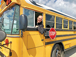 Father Michael Keucher, archdiocesan vocations director, says earning a license to drive a school bus has helped him lead the Catholics he serves as pastor of St. Joseph Parish in Shelbyville and as sacramental minister of St. Vincent de Paul Parish in Shelby County to grow closer to Christ by taking them on pilgrimages and service trips. &ldquo;Maybe it&rsquo;s just a matter of getting people on the bus,&rdquo; says Father Keucher. &ldquo;Get on the bus. And God has allowed me to be behind the wheel.&rdquo; Read his story on page 2B. (Submitted photo)