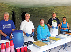 Members of the Indianapolis Serra Club assist in serving a meal at Bishop Brut&eacute; Days, an annual vocations camp and retreat for junior high and high school boys, held at Bishop Simon Brut&eacute; College Seminary in Indianapolis. They are, from left, Rick Santangelo, Jim Cain, Louise Collet and Joe Dwenger. Also pictured is Ann Berkemeier, right, the wife of Serran Art Berkemeier. She often assists at club events. (Submitted photo)