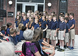 Students of Lumen Christi Catholic School in Indianapolis sing a patriotic song during a Sept.&nbsp;23 ceremony to dedicate and bless a plaque to honor four students of the former Latin School of Indianapolis who died while serving in the U.S. military. (Photos by Sean Gallagher)