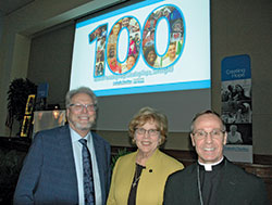 The archdiocese&rsquo;s Catholic Charities executive director David Bethuram, left, Catholic Charities USA president and chief executive officer Dominican Sister Donna Markham, and Archbishop Charles C. Thompson are all smiles in the Archbishop Edward T. O&rsquo;Meara Catholic Center in Indianapolis after the 100th anniversary celebration dinner on Nov. 20 for Catholic Charities in the archdiocese. (Photo by John Shaughnessy) 