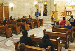 Father Lawrence Richardt looks on as Paul Giesting, left, thanks those who came to the archdiocese&rsquo;s first Gold Mass for Scientists, which he helped coordinate, in the chapel of SS. Peter and Paul Cathedral in Indianapolis on Nov. 15, the feast of St. Albert the Great, patron of scientists. (Photo by Natalie Hoefer)