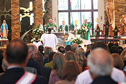 St. Malachy Parish pastor Father Sean Danda, left, Deacon Dan Collier, Archbishop Charles C. Thompson and Deacon Rick Renzi gather around the altar of St. Malachy Church in Brownsburg during a Mass celebrating the parish&rsquo;s 150th anniversary on Nov. 3. (Submitted photo by David Gansert)