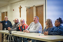 Russell Boyd, center, speaks about his imprisonment for more than 43 years, 10 of which were spent on Indiana&rsquo;s death row, during the Corrections Ministry Conference at St. Paul Catholic Center in Bloomington on Nov. 16. Boyd was part of a panel of formerly incarcerated persons led by Deacon Marc Kellams, far left. The conference was the third of its type and marks an increased effort by the archdiocese to better organize and equip people who minister in jails and prisons. Panel members included Richard Samuels, left, David Steele, Russell Boyd, Maria Luttrell and Jay David. (Photos by Katie Rutter)