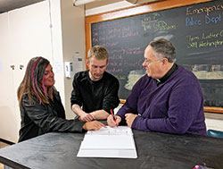 As part of the approach of the Men&rsquo;s Warming Shelter of Bedford, Father Richard Eldred, pastor of St. Vincent de Paul Parish in Bedford and director Jennifer Richason help homeless men develop a plan to reach self-sufficiency. (Submitted photo)