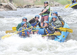 Archdiocesan high school students experience the adrenaline of rushing through white-water rapids&mdash;one of the many adventures during the annual Summer Field Study program led by Joseph Hollowell, president of Roncalli High School in Indianapolis, for nearly 40 years. (Submitted photo)