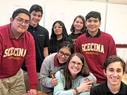 Amy Fix, this year&rsquo;s recipient of the archdiocese&rsquo;s highest honor for an educator, gets a hug from Ani Ximeyo Coyotl. The teacher at Father Thomas Scecina Memorial High School in Indianapolis is also surrounded by other smiling Scecina students: Sammy Villanueva Pupo, left, Angel Anaya, Stephanie Meza, Katherine Guerra-Cordova, Edson Cuellar Mora and Thiago Rodrigues. (Submitted photo by Beth Murphy)