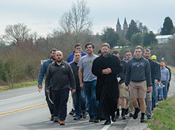 Led by Benedictine Father Christian Raab, seminarians in formation for the priesthood at Saint Meinrad Seminary and School of Theology in St. Meinrad walk on March 13 along State Road 62 outside of the southern Indiana town while on a pilgrimage to the Shrine of Our Lady Monte Cassino. They sought Mary&rsquo;s intercession in response to the growing outbreak in the U.S. of the coronavirus. (Submitted photo by Corey Bruns)