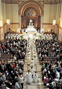 Archbishop Charles C. Thompson and some 140 priests serving in central and southern Indiana process on April 16, 2019, into SS. Peter and Paul Cathedral in Indianapolis at the start of the annual archdiocesan chrism Mass. This year&rsquo;s chrism Mass was postponed due to the coronavirus pandemic. (File photo by Sean Gallagher)