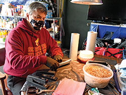 Jim Donlan, a member of Holy Spirit Parish in Indianapolis, assembles a mask on April 9 in the garage of his home on the east side of Indianapolis. In less than three weeks, Donlan and volunteers who have come to his home have made and given away some 2,800 masks that can be used to help stop the spread of the coronavirus. (Photo by Sean Gallagher)&nbsp;