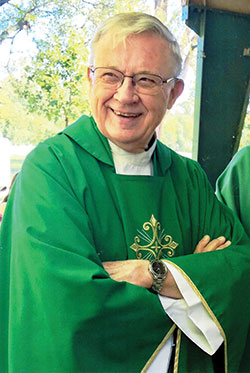 Father James Bonke shares a smile after Christ the King Parish&rsquo;s Mass at Broad Ripple Park, both in Indianapolis, in September 2019. (Submitted photo)