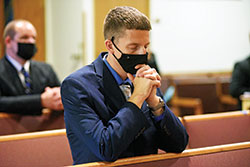 Seminarian Jack Wright, a member of St. Elizabeth Ann Seton Parish in Richmond, kneels in prayer during an Aug. 3 Mass in the chapel of Our Lady of Fatima Retreat House in Indianapolis. The liturgy was part of the archdiocesan seminarians&rsquo; annual convocation. (Photo by Sean Gallagher)