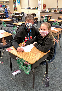 As she works with her students, Sandi Kirchner of St. Mary School in North Vernon encourages them to follow her lead in &ldquo;trying to be the best person I can be every day.&rdquo; Here, she helps one of her students, Kennedei Roll. (Submitted photo)
