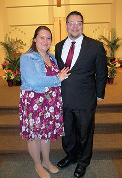Brian Hall smiles with his sponsor and fianc&eacute;e Cari Weibel in St. Lawrence Church in Indianapolis after being received into the full communion of the Church during the Easter Vigil Mass on April 3. (Submitted photo by Sandra Hartlieb)