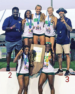 The runners and coaches of the girls&rsquo; track team of Cathedral High School in Indianapolis are all smiles as they celebrate their 2021 Indiana High School Athletic Association Track and Field State Championship victory on June 5 in Indianapolis. Kaylah Pitts, left, and Alexis Parchman are in the bottom row while Coach Josiah Daniels, left, Milani Kimble, Reese Sanders, Sidney Sanders and Coach John O&rsquo;Hara form the top row. (Submitted photo)