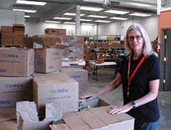 As the director of the Boulevard Place St. Vincent de Paul Food Pantry, Cindy Brown is all smiles about the improvements that were part of the recent physical transformation of the pantry building&mdash;improvements that have created a quicker, more comfortable shopping experience for people in need.  (Photo by John Shaughnessy)