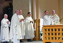 Archbishop Charles C. Thompson elevates the Eucharst at SS. Peter and Paul Cathedral in Indianapolis on Sept. 23 during a special Mass for those who contributed $1,500 or more to this year&rsquo;s annual United Catholic Appeal. Concelebrating with the archbishop are Msgr. William F. Stumpf, second from left, Father Patrick Beidelman, Father Eric Augenstein and Msgr. Joseph Schaedel. Assisting with the Mass is Deacon Stephen Hodges, left. (Photo by Natalie Hoefer)