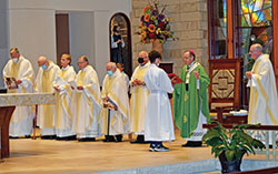 Archbishop Charles C. Thompson serves as principal celebrant at the Miter Society Mass in St. Mary-of-the-Knobs Church in Floyd County on Oct. 21. Concelebrating with him are Fathers William Marks, left, William Ernst, Anthony Hollowell, Stephen Banet, Daniel Atkins, Wilfred &ldquo;Sonny&rdquo; Day and Msgr. William F. Stumpf. Altar server Garrett Jennings holds the missal for the archbishop. (Submitted photo by Leslie Lynch)