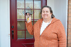Linda Kile, president and director of Gabriel Project, smiles with joy as she holds the keys to the southwest side Indianapolis home recently purchased as the new site of the organization&rsquo;s 1st Choice for Women pregnancy care center, which has been without headquarters since their offices were burned in a building fire in 2019. Pending rezoning the property for commercial use, she hopes the pregnancy care center will open in the summer. (Photo by Natalie Hoefer)