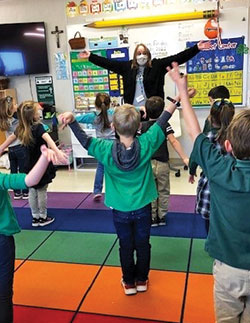 Social worker Patrice Uminski leads pre-school students at St. Malachy School in Brownsburg in practicing taking &ldquo;mountain breaths&rdquo; to help them calm down when they struggle with their motions.&nbsp;(Submitted photo)