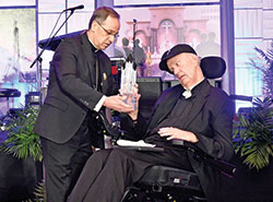 Archbishop Charles C. Thompson presents the archdiocese&rsquo;s Legacy Award to Msgr. Paul Koetter during the Legacy Gala at the JW Marriott hotel in Indianapolis on Feb. 25. Msgr. Koetter received the Legacy Award in honor of his ministry to serve God and people across central and southern Indiana in his 45 years of priesthood. (Photo by Rob Banayote)