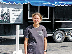 As the director of the Emmaus Ministry at St. John the Evangelist Parish in downtown Indianapolis that serves the homeless, Danielle Heitkamp stands in front of the parish&rsquo;s new, deluxe food trailer that is key to that effort. (Photo by John Shaughnessy)