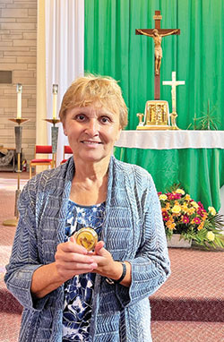 As an extraordinary minister of holy Communion, Marianne Warthan of St. Paul Catholic Center in Bloomington believes her ministry is &ldquo;the most rewarding one in the Church.&rdquo; She displays a pyx, which holds Communion taken to sick and homebound Catholics. (Submitted photo)