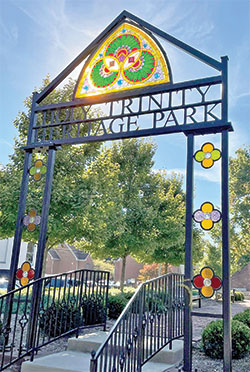 Sunlight streams through a restored, 132-year-old stained-glass window that survived a devastating fire that destroyed the former Holy Trinity Church in New Albany. The window now welcomes visitors to Holy Trinity Heritage Park in New Albany. The structure and a new statue were blessed by Father Wilfred &ldquo;Sonny&rdquo; Day on Oct. 4. (Submitted photo courtesy of St. Elizabeth Catholic Charities in New Albany)