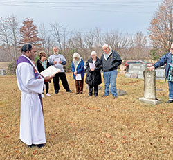 Father Jeyaseelan &ldquo;Jey&rdquo; Sengolraj, administrator of St. Francis Xavier Parish in Henryville, leads a prayer in the parish&rsquo;s cemetery on Nov. 2, All Souls&rsquo; Day. (Submitted photo)