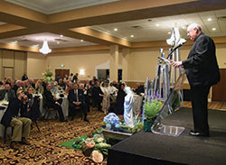 Msgr. Joseph Schaedel, right, speaks on Oct. 18 to attendees of the annual Catholic Radio Indy fundraising dinner after receiving the radio apostolate&rsquo;s Archbishop Fulton J. Sheen Evangelist of the Year Award. (Photo by Sean Gallagher)