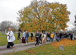 Father C. Ryan McCarthy, pastor of Our Lady of the Most Holy Rosary Parish in Indianapolis, leads Catholics on Nov. 5 in his parish&rsquo;s eighth annual Indulgence Walk through Holy Cross and St. Joseph cemeteries in Indianapolis. (Photo by Sean Gallagher)