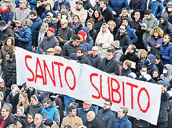 People hold up a sign saying, &ldquo;santo subito&rdquo; (&ldquo;sainthood now&rdquo;) at the end of the funeral Mass for Pope Benedict XVI in St. Peter&rsquo;s Square at the Vatican on Jan. 5. (CNS photo/Chris Warde-Jones)