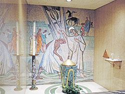 Peter Recker created the mosaic work for the church&rsquo;s baptistry and the triangular bronze ambry installed in the right-side wall, and also designed the baptismal font. &ldquo;The mosaic is of [St.] Philip baptizing the Ethiopian,&rdquo; as told in Acts 8:26-40, says Caleb Legg. &ldquo;It&rsquo;s another nod to the African American, symbolizing that Blacks have been part of the Catholic faith from the very beginning of Christianity.&rdquo; As for the bronze ambry, Legg notes that Recker &ldquo;created all the bronze works in the church.&rdquo; (Submitted photos by Caleb Legg)