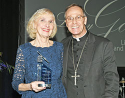 Archbishop Charles C. Thompson poses for a photo with Mary Jo Thomas-Day after she received the archdiocese&rsquo;s Legacy Award at the Legacy Gala at the JW Marriott in Indianapolis on Feb. 10. (Photo by Rob Banayote)