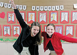 The smiles of Alexandra &ldquo;Alex&rdquo; Daley, left, and Ella Spoonmore show their close friendship, a friendship that has helped the two fifth-grade students at St. Charles Borromeo School in Bloomington lead drives that have collected nearly 10,000 pounds of food in the past two years to help families in southern Indiana. (Photo by John Shaughnessy)